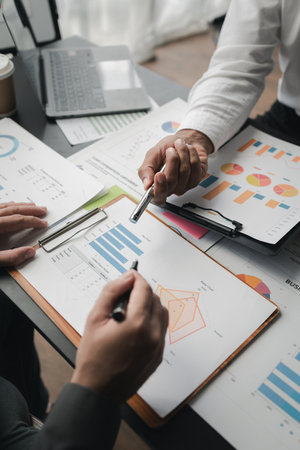In a meeting between the finance and marketing departments to discuss work plans, two startup employees are brainstorming ideas for a profitable operating plan. Planning meeting concept.の写真素材