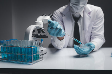 Lab assistant, a medical scientist, a chemistry researcher holds a glass tube through the blood...