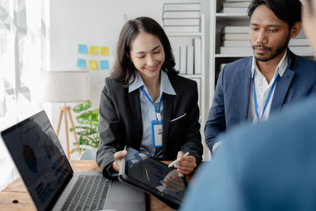 A group of businessmen and marketers meet in a company meeting room, a group of investors and executives plan marketing plans to find ways to make profits and grow. Marketing planning meeting ideas.の写真素材