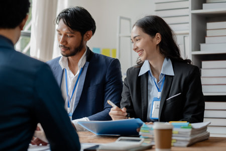 A group of businessmen and marketers meet in a company meeting room, a group of investors and executives plan marketing plans to find ways to make profits and grow. Marketing planning meeting ideas.の写真素材