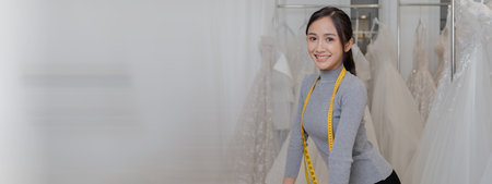 Asian women own dress design and tailoring shops, wedding dress business owners, sell clothes online on websites and live sell via social media. Wedding dress and souvenir business ideas.の写真素材