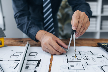 Architects sketch and edit real estate building plans, design buildings according to standards and plan structures, draw professional floor plans. Real estate design and construction concepts.の写真素材