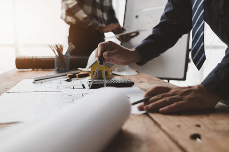 The home design architects are reviewing the house plan draft, the project commissioned by the client, and the custom design before delivery. Interior design and decoration ideas.の写真素材