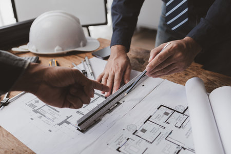 The home design architects are reviewing the house plan draft, the project commissioned by the...