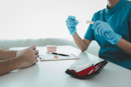 Man undergoes a dental checkup with professional dentist at dental clinic, undergoes a dental checkup with a professional dentist and receives oral care advice. Concept of receiving dental treatment.の写真素材