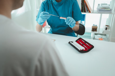 Man undergoes a dental checkup with professional dentist at dental clinic, undergoes a dental checkup with a professional dentist and receives oral care advice. Concept of receiving dental treatment.の写真素材