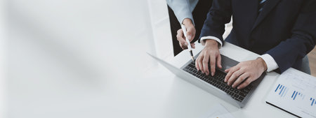 Finance and Marketing Business Meeting, Two businessmen are meeting together and looking at financial and marketing documents to plan how to grow their business. Business meeting concept.の写真素材