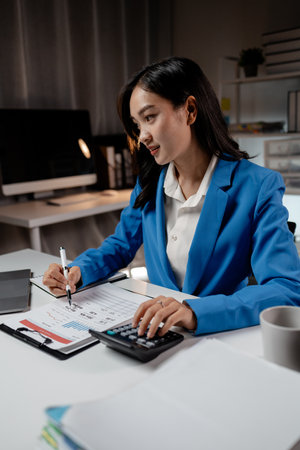 Business woman working in a startup company, female accountant working in auditing the company's accounts and finances, accounting and finance. Accounting and financial auditing concepts.の写真素材