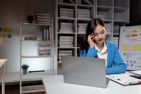 Asian women are stressed and tired from long hours of work, and businesswomen work hard causing office syndrome that often occurs in working people. The concept of office syndrome.の写真素材