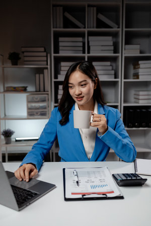 Business woman working in a startup company, female accountant working in auditing the company's accounts and finances, accounting and finance. Accounting and financial auditing concepts.の写真素材