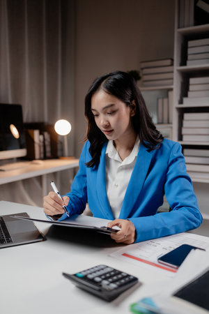Business woman working in a startup company, female accountant working in auditing the company's accounts and finances, accounting and finance. Accounting and financial auditing concepts.の写真素材
