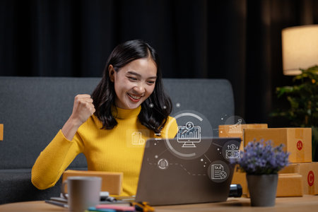 An online business owner, she sells products on a website and manages an online store on the Internet, taking orders and packing products for delivery to customers with a private courier service.の写真素材