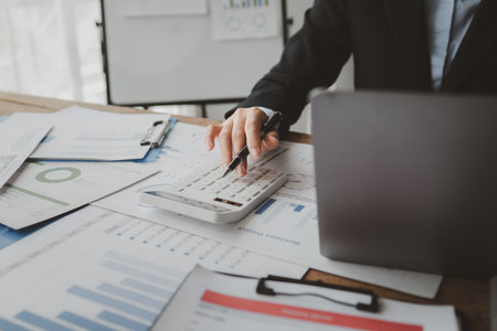Accountant calculating numbers on calculator, Auditor is working on accounting in the office, Businessman calculating the financial liquidity of the company, accounting idea.の写真素材