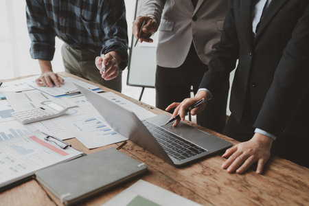 Group of businessmen working together to calculate income, They are revising the financial numbers, Take out financial documents and check them with a calculator, financial idea.の写真素材
