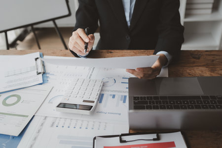Accountant calculating numbers on calculator, Auditor is working on accounting in the office, Businessman calculating the financial liquidity of the company, accounting idea.の写真素材