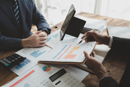 Businessmen are attending a meeting about finances, Discussing tax payments in the conference room, Meeting to plan marketing to increase operating results, Business meeting idea.の写真素材