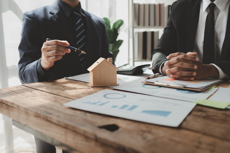 Talking with a real estate expert, Discuss property investments, A customer is having a financial meeting with an investment professional regarding the purchase of a home, real estate idea.の写真素材