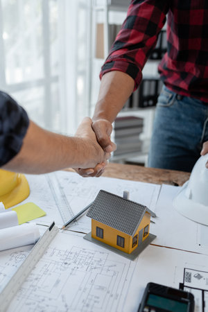 Architects and engineers agree on blueprints together, An agreement is being made regarding the structure of the building, The plan has been approved by the architect, architect idea.の写真素材