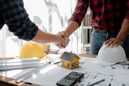 Architects and engineers agree on blueprints together, An agreement is being made regarding the structure of the building, The plan has been approved by the architect, architect idea.の写真素材