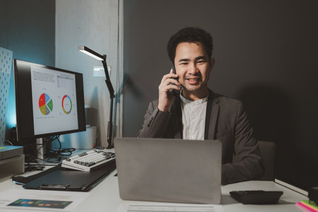 he is using his phone to find information to use in presenting information, Entrepreneurs use smartphones to keep in touch with business partners while working in the company, startup idea.の写真素材