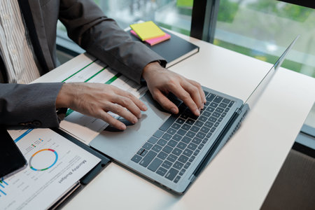 Entrepreneurs sit and plan work in the company, An employee is sitting in the office looking for information about a startup company, Use a laptop to compile documents for presentations, startup idea.の写真素材