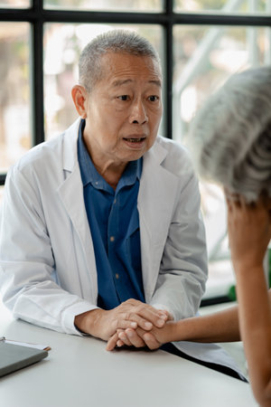 Doctor examining an elderly patient, An elderly patient is being diagnosed by a doctor in the hospital, The doctor is explaining the treatment plan to the patient, doctor idea.の写真素材
