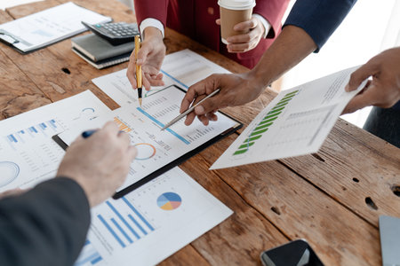 Group of businessmen working together to calculate income, They are revising the financial numbers, Take out financial documents and check them with a calculator,の写真素材