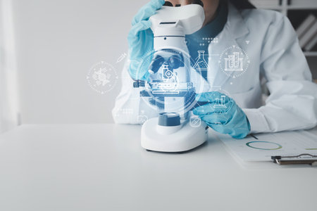 chemist is doing an experiment in the laboratory, A scientist is using a microscope to analyze the chemical composition, A scientific experiment is searching for biological answers in a laboratory.の写真素材