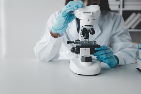 chemist is doing an experiment in the laboratory, A scientist is using a microscope to analyze the chemical composition, A scientific experiment is searching for biological answers in a laboratory.の写真素材