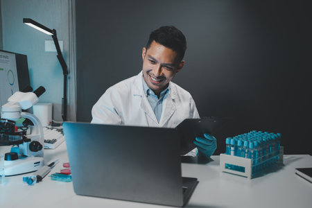 Chemist is chemically analyzing test tubes, Scientist is experimenting with chemicals in the laboratory, Chemist is separating compounds in test tubes with chemical reagents.の写真素材