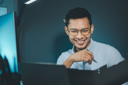 Businessman is sitting and working in the office, Employee is looking for information on laptop, An entrepreneur is talking on the phone with a company customer,の写真素材