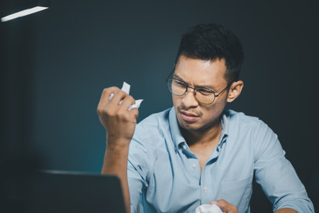 Businessman is stressed because of business problems in the office, worried about the company's...
