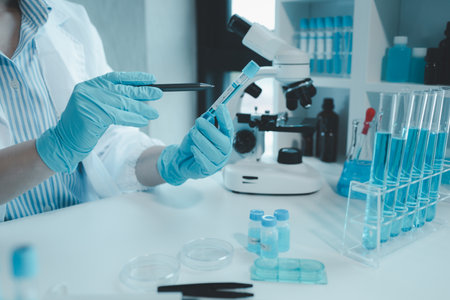 Chemist is chemically analyzing test tubes, Scientist is experimenting with chemicals in the laboratory, Chemist is separating compounds in test tubes with chemical reagents,の写真素材