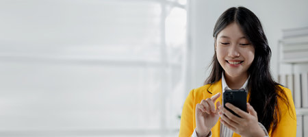 Businesswoman is working in the office and talking on the phone with a partner, Entrepreneurs use...