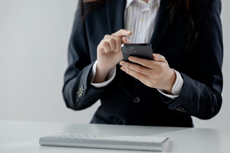 Businesswoman is working in the office and talking on the phone with a partner, Entrepreneurs use...