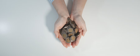 The accountant held out a handful of coins, A financier collects some coins from customers, Employees offer customers efficient ways to save money.の写真素材