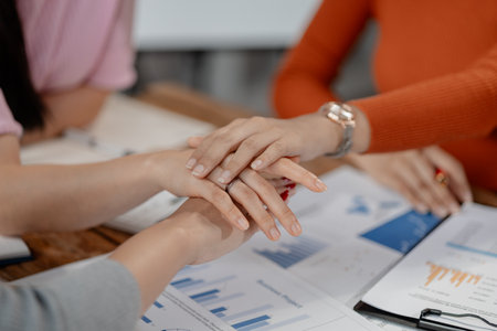 Stack of hands showing unity and teamwork, Close-up of co-workers stacking their hands together, Positive team motivation, Business team standing hands together,の写真素材