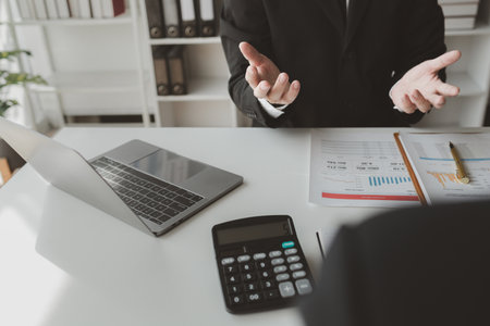 Group of businessmen working together to calculate income, They are revising the financial numbers,...