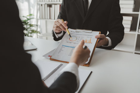 Group of businessmen working together to calculate income, They are revising the financial numbers, Take out financial documents and check them with a calculator,の写真素材