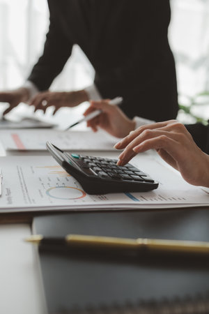They are planning finances for expenses within the company, Meeting on reporting tax payments, Calculate the numbers according to the report sent to the meeting,の写真素材