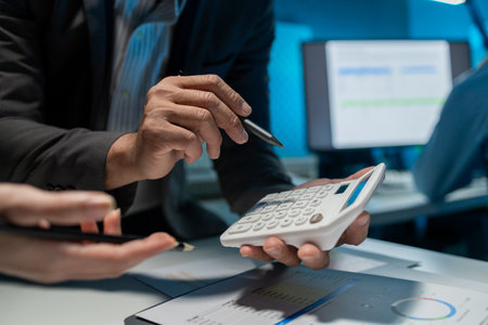 They are having a meeting about the company's income and expenses, team of analyst working on financial data analysis dashboard on paper as marketing indication for business strategic planning.の写真素材