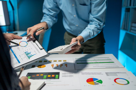 They are having a meeting about the company's income and expenses, team of analyst working on financial data analysis dashboard on paper as marketing indication for business strategic planning.の写真素材