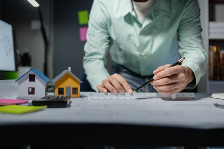 Commercial buildings are being evaluated by architects on what type of construction they need to be built, Engineers are designing a structure according to blueprints,の写真素材