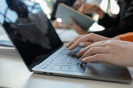 Mixed group of business people sitting around a table and working, Business team working on a...