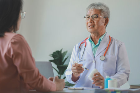 The doctor is explaining the details of the medicine that the patient must take, A patient comes to see the doctor about the problem of side effects from taking medicine.の写真素材