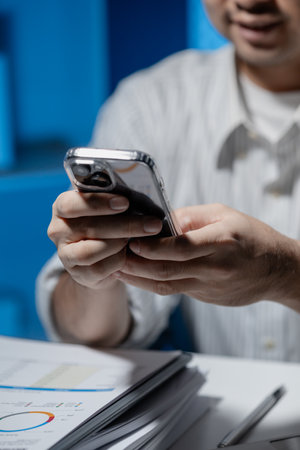 One employee is working overtime, Overtime employees are using their smartphones to find important...