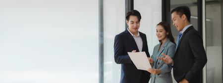 A group of employees happily work together in the office while discussing work that was completed on time as ordered by their boss, A group of entrepreneurs had fun working together.の写真素材
