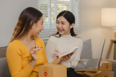 The two entrepreneurs are very happy with their sales exceeding their expectations, The two co-workers were very happy because they had completed their assigned tasks.の写真素材