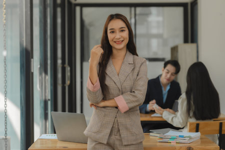picture of businesspeople is looking into the camera in the office, front view of an entrepreneur smiling and posing with confidence, portrait of executive staffの写真素材