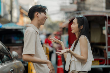 the young lovely couple is walking around traditional food market under the sun, love is showing from their face when they have conversation because they love each other, datingの写真素材